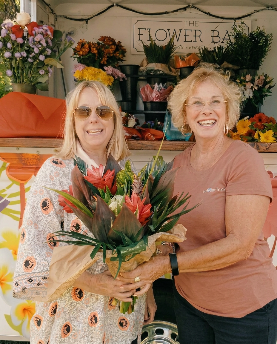 Shirley, founder of The Flower Truck, in a sunlit floral studio